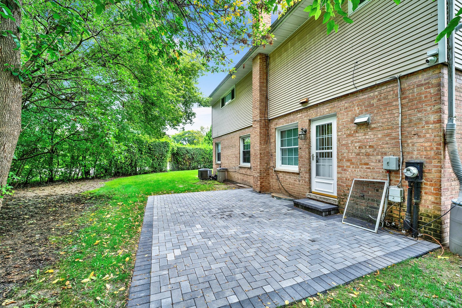 8950 East Prairie Road Evanston, IL 60203 - Photo 3 of 25 a view of a house with backyard and a patio