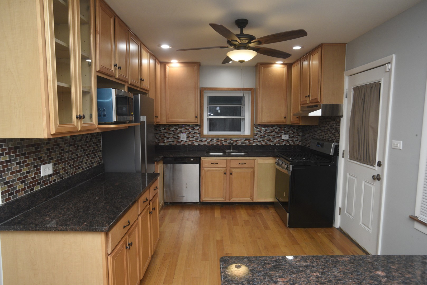 8950 East Prairie Road Evanston, IL 60203 - Photo 10 of 25 a kitchen with a sink a stove and cabinets