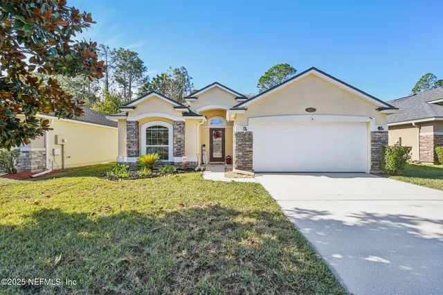 a front view of a house with a yard and garage