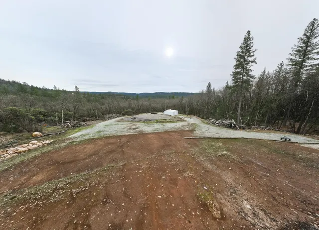 a view of dirt yard with mountain