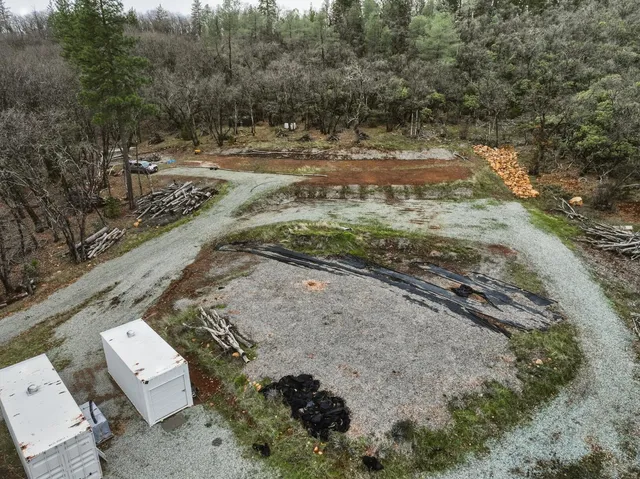 a view of a yard with wooden fence
