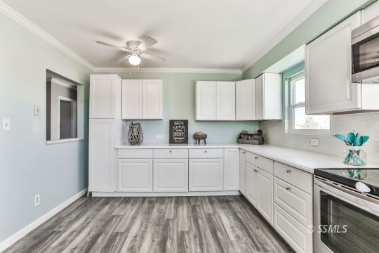 1415 Mayo Street Ridgecrest, CA 93555 - Photo 5 of 34 a kitchen with a cabinets appliances and a window