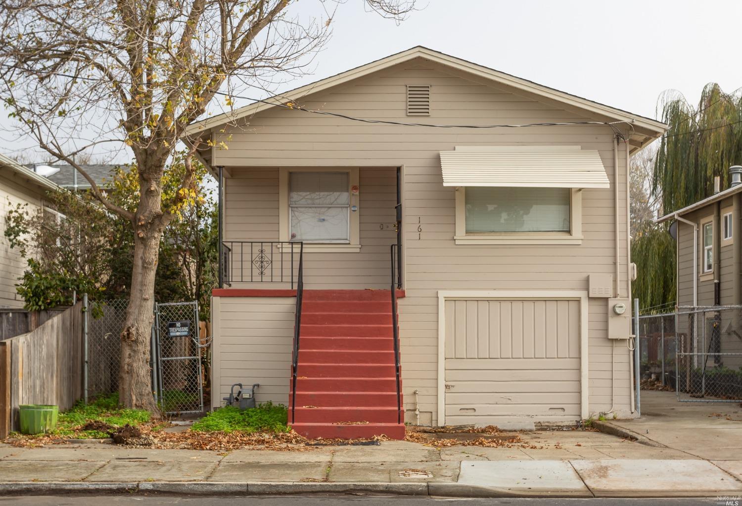 161 Vaqueros Avenue Rodeo, CA 94572 - Photo 1 of 1 a front view of a house with a yard and garage