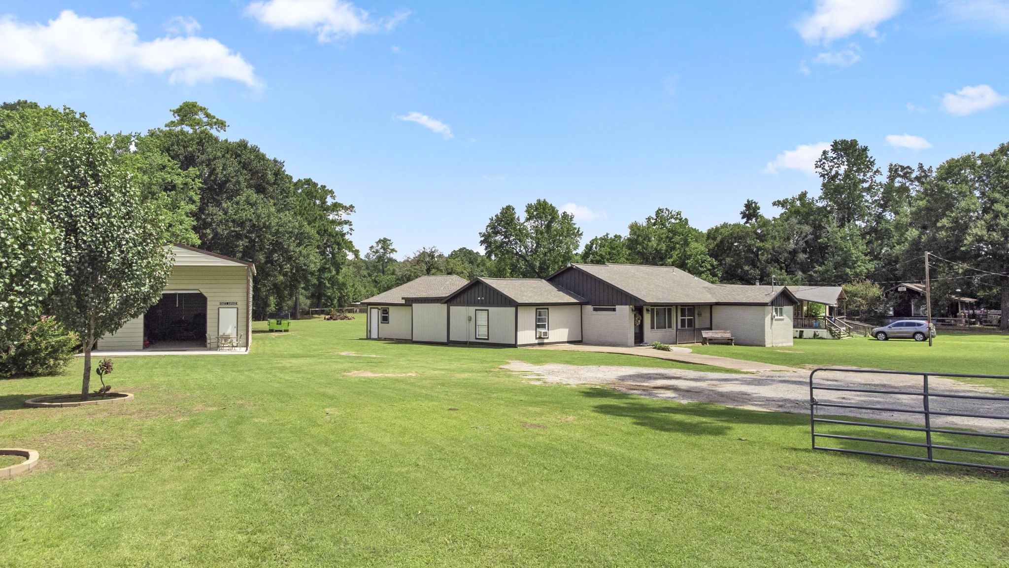 a house with a big yard and large trees