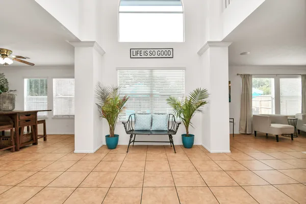 a living room with furniture and a potted plant