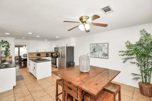 a kitchen with a table and chairs