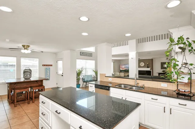 a kitchen with granite countertop a sink and a counter top space