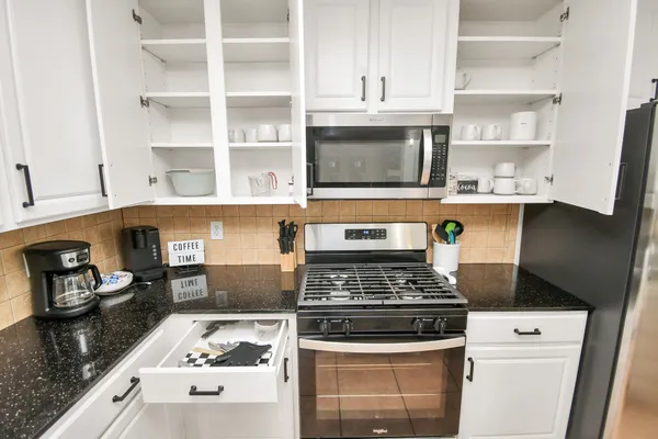 a kitchen with cabinets and appliances