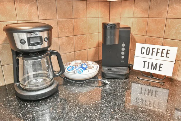 a kitchen with granite countertop a refrigerator and a stove