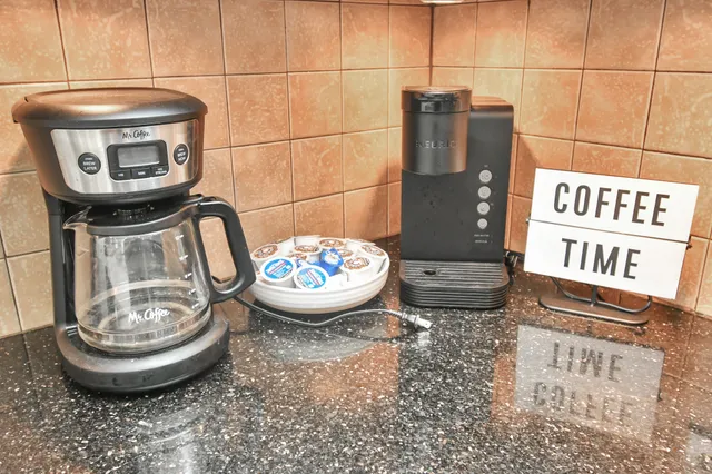 a kitchen with granite countertop a refrigerator and a stove