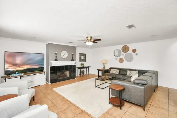 a living room with furniture a fireplace and a flat screen tv