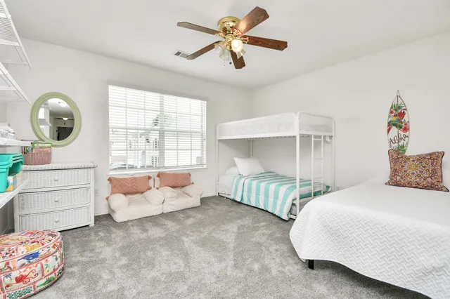 a bedroom with a bed a couch and a window