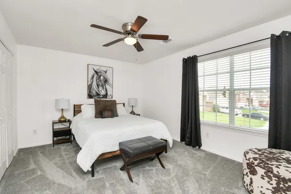 a bedroom with a bed and a chair