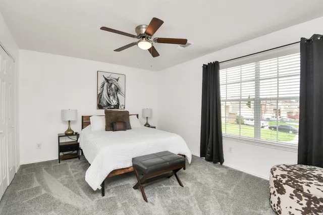 a bedroom with a bed and a chair