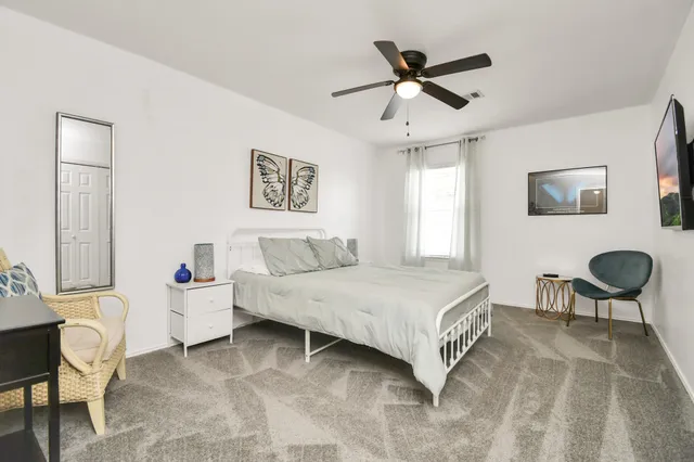 a bedroom with a bed and a chandelier