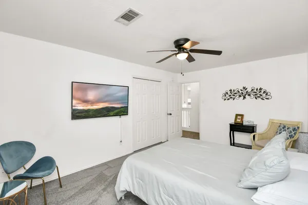 a bedroom with 2 bed and a chandelier