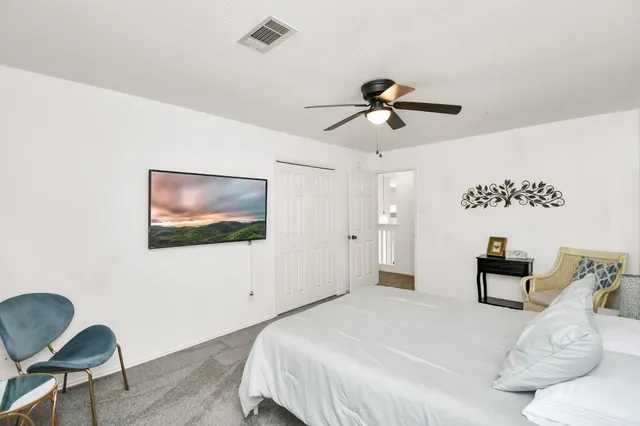 a bedroom with 2 bed and a chandelier