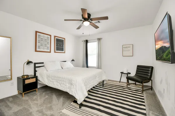 a spacious bedroom with two beds and a couch