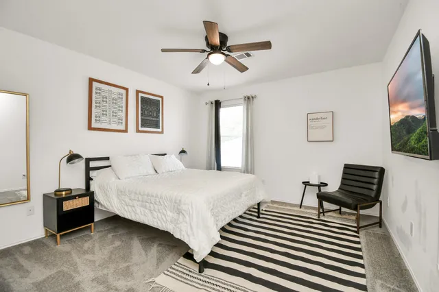 a spacious bedroom with two beds and a couch