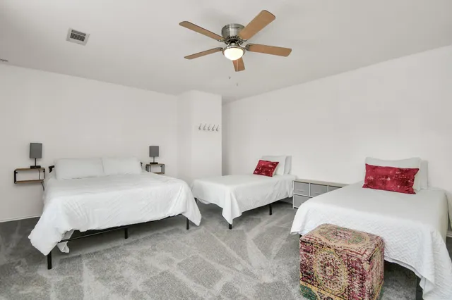 a spacious bathroom with a double vanity sink a mirror and a