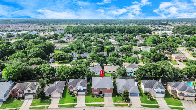 a view of a house with backyard and sitting area