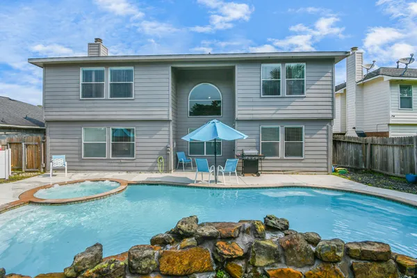 a view of a backyard with table and chairs potted plants