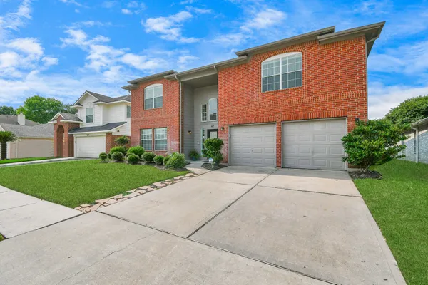 a front view of a house with swimming pool and porch
