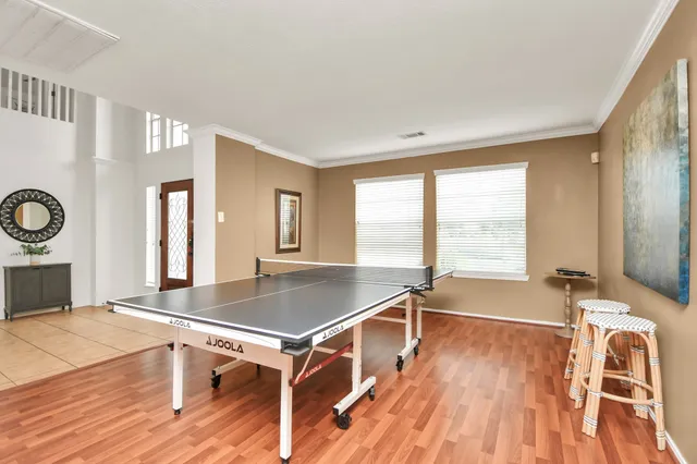 a room with wooden floor and window