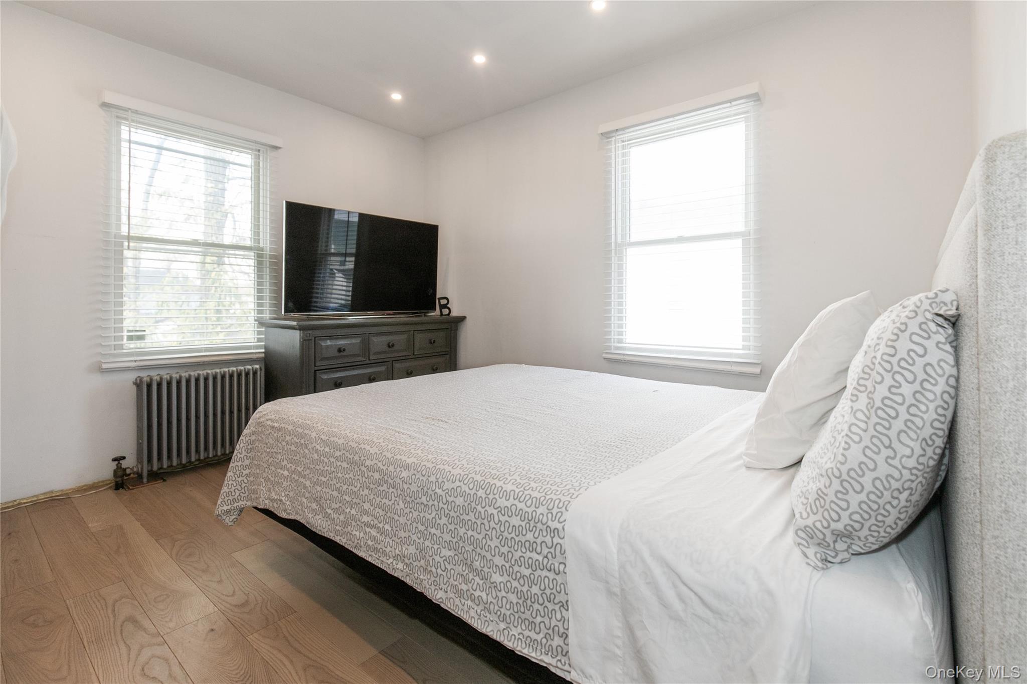 34 Avondale Street Valley Stream, NY 11581 - Photo 11 of 20 a bedroom with a bed and a flat screen tv