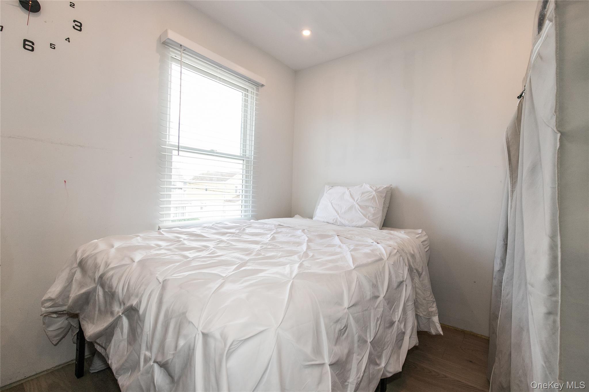 34 Avondale Street Valley Stream, NY 11581 - Photo 13 of 20 a bed sitting in a bedroom next to a window