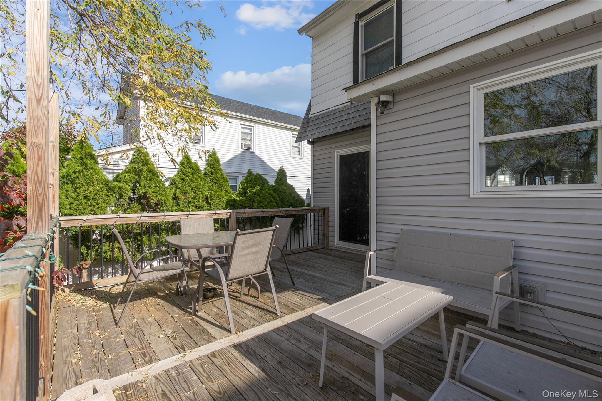 34 Avondale Street Valley Stream, NY 11581 - Photo 18 of 20 a view of a patio with table and chairs and wooden floor