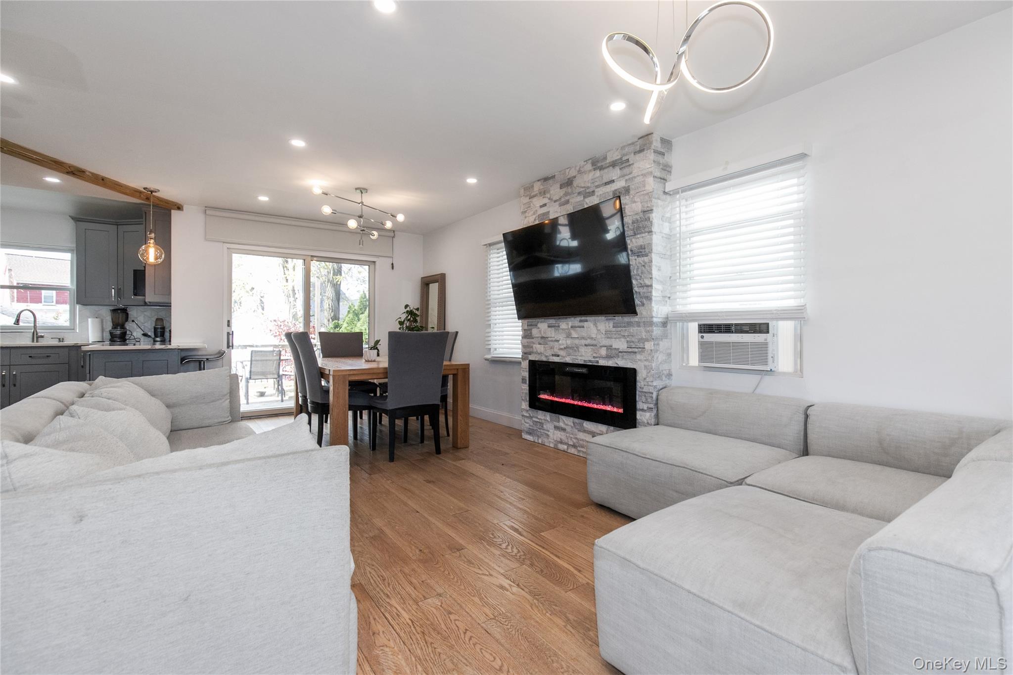 34 Avondale Street Valley Stream, NY 11581 - Photo 4 of 20 a living room with furniture a fireplace and a flat screen tv