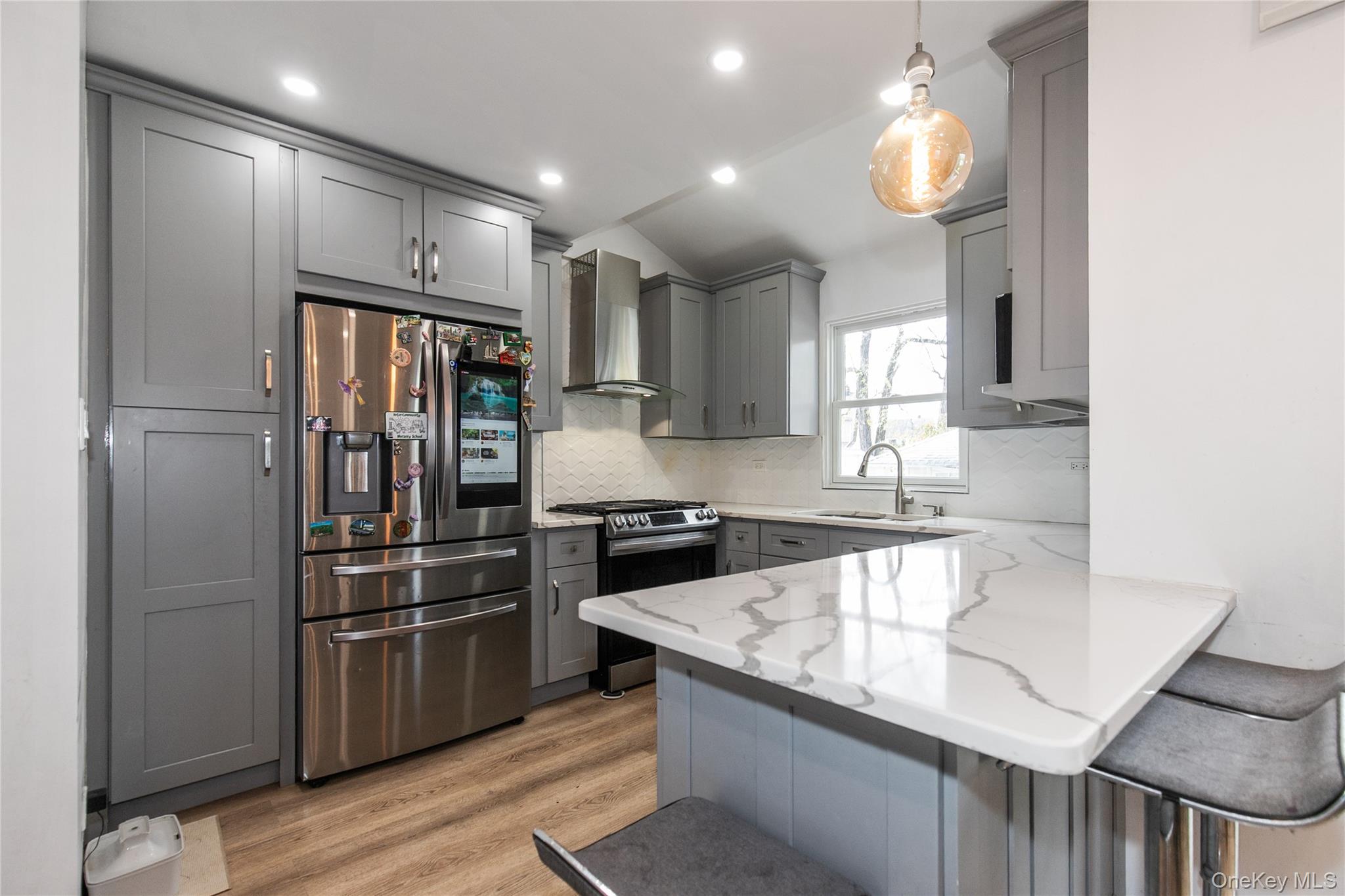 34 Avondale Street Valley Stream, NY 11581 - Photo 7 of 20 a kitchen with a refrigerator a sink and cabinets