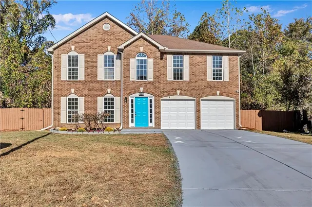 a front view of a house with a yard and garage