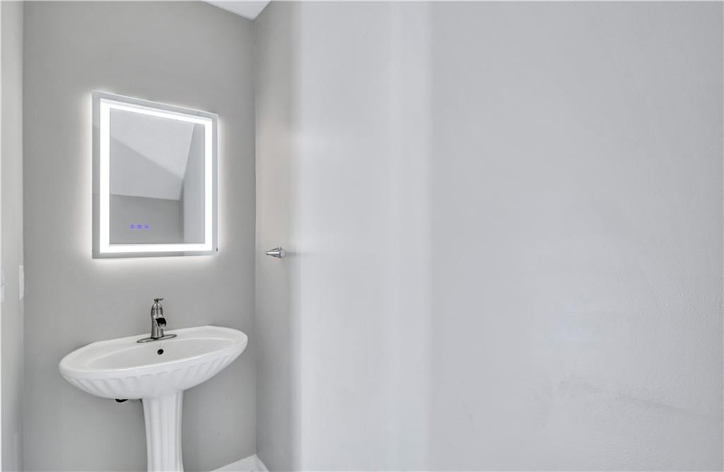 4061 Jewel Terrace Conley, GA 30288 - Photo 16 of 36 a bathroom with a sink and mirror