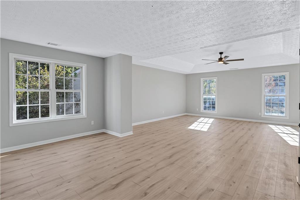 4061 Jewel Terrace Conley, GA 30288 - Photo 17 of 36 a view of empty room with wooden floor and fan