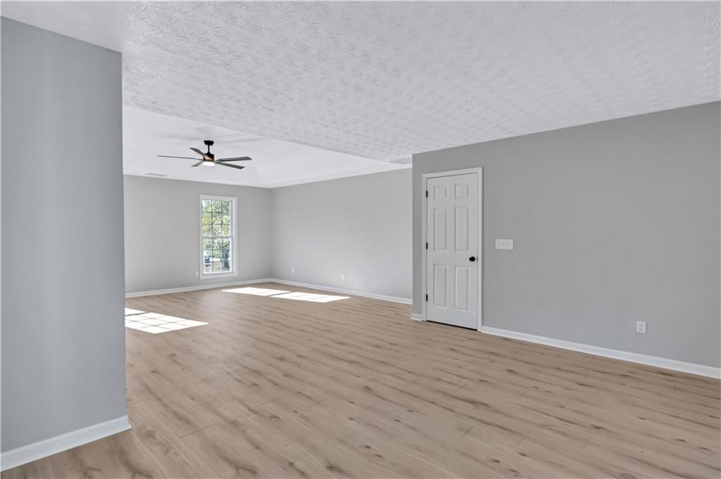 4061 Jewel Terrace Conley, GA 30288 - Photo 20 of 36 a view of an empty room with wooden floor and a window