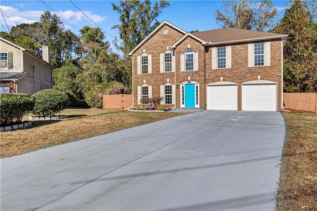 4061 Jewel Terrace Conley, GA 30288 - Photo 2 of 36 a front view of a house with a yard and garage