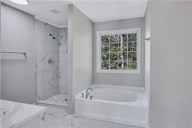 a bathroom with a bathtub and a shower