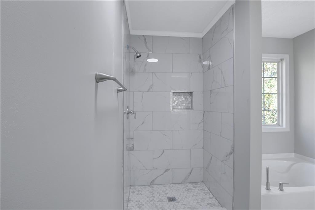 4061 Jewel Terrace Conley, GA 30288 - Photo 24 of 36 a bathroom with a bathtub and shower