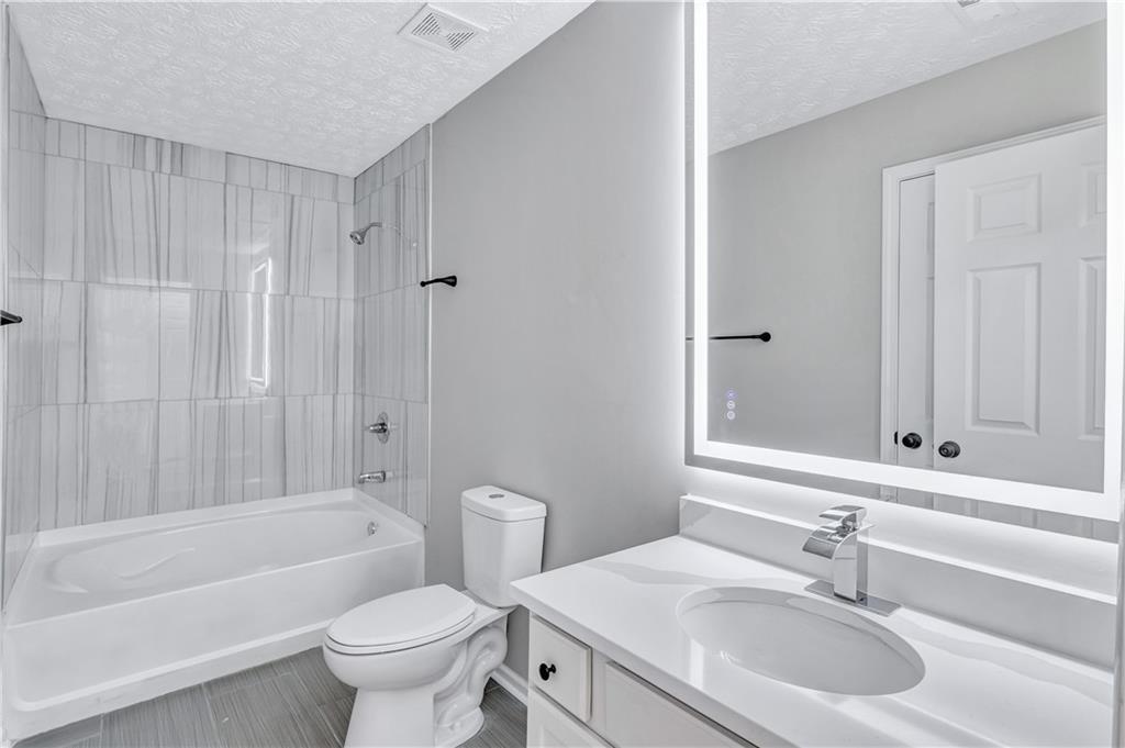 4061 Jewel Terrace Conley, GA 30288 - Photo 29 of 36 a bathroom with a sink toilet and shower