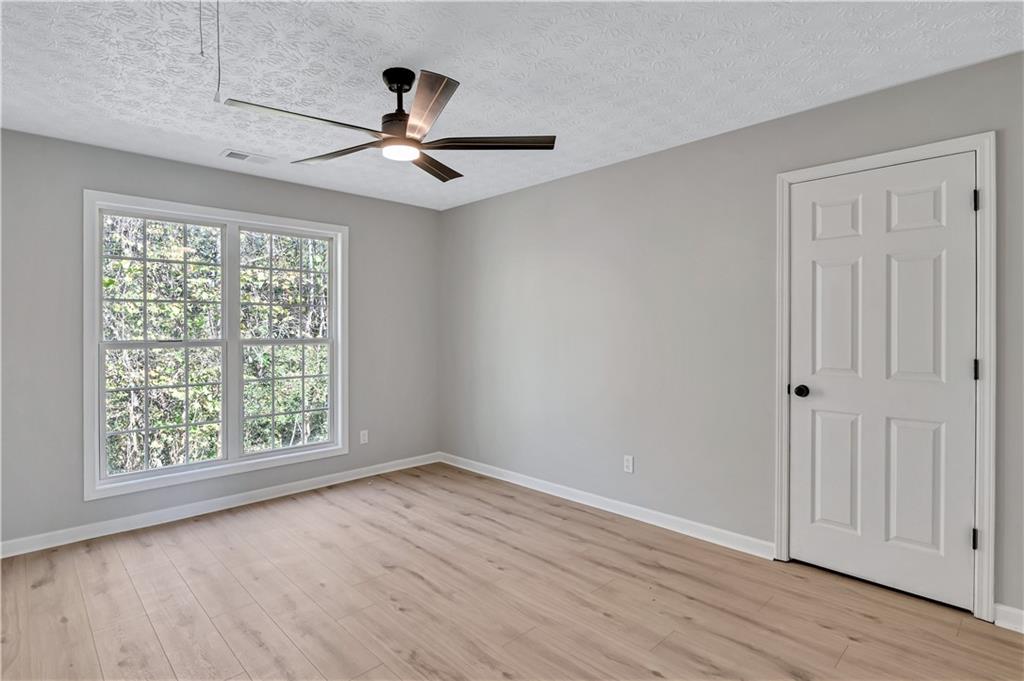 4061 Jewel Terrace Conley, GA 30288 - Photo 33 of 36 wooden floor in an empty room with a window