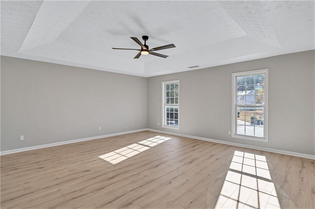 4061 Jewel Terrace Conley, GA 30288 - Photo 34 of 36 a view of an empty room with a window and wooden floor