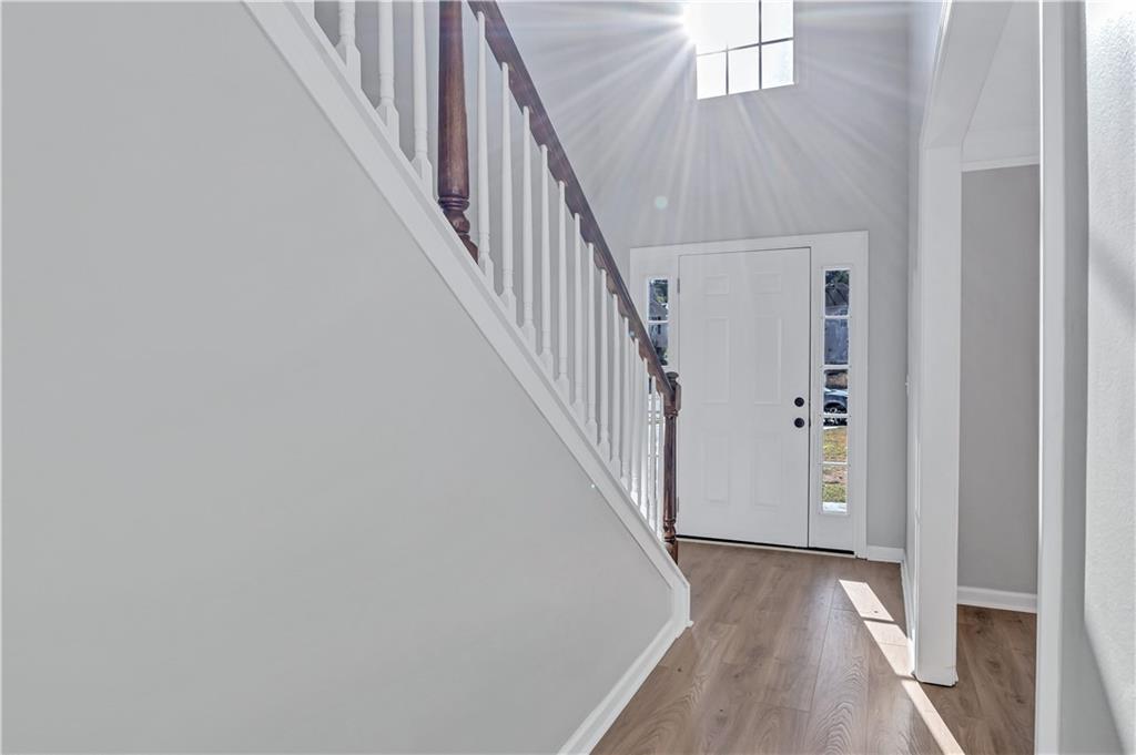 4061 Jewel Terrace Conley, GA 30288 - Photo 4 of 36 a view of a hallway with wooden floor and entryway