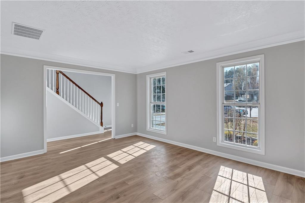 4061 Jewel Terrace Conley, GA 30288 - Photo 6 of 36 a view of empty room with wooden floor and fan