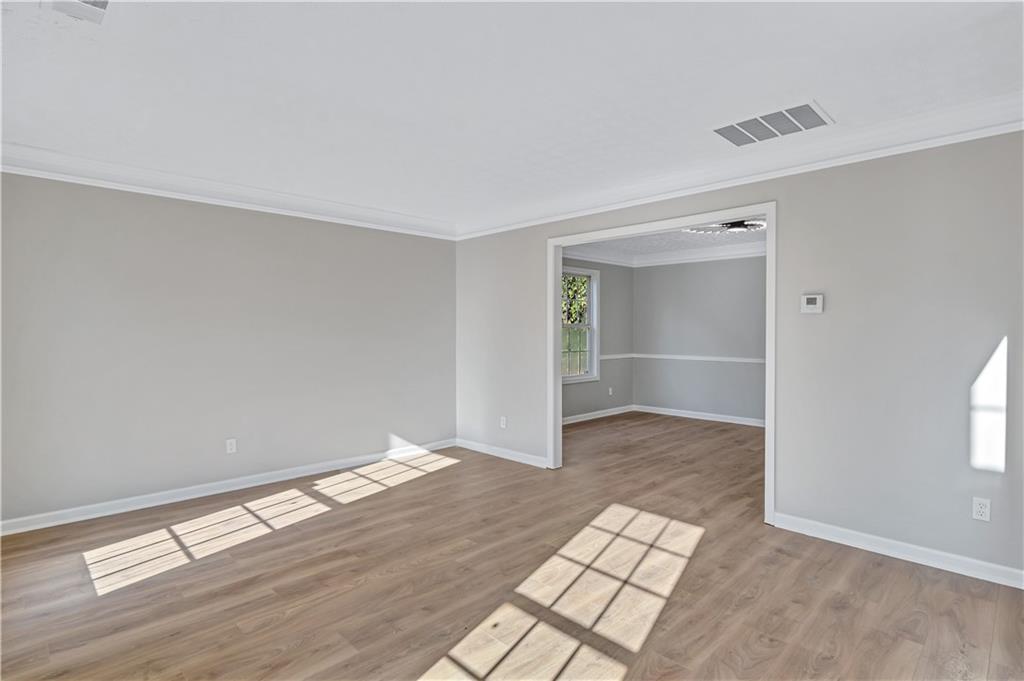 4061 Jewel Terrace Conley, GA 30288 - Photo 7 of 36 an empty room with wooden floor & windows