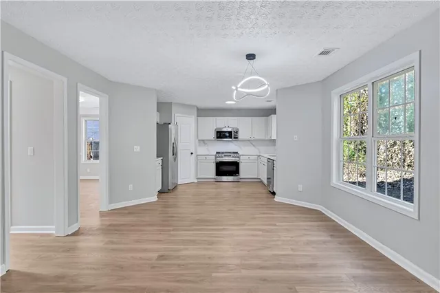 a view of a kitchen with a sink and a window