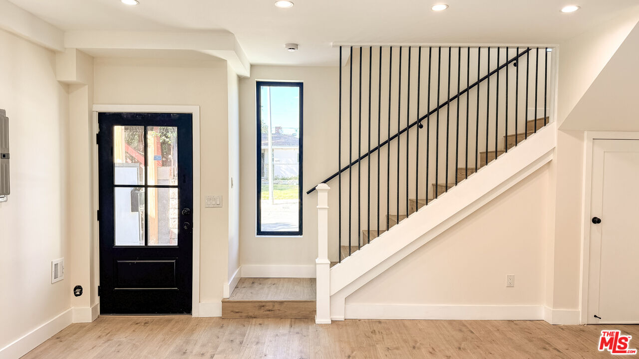 19557 Calvert Street Tarzana, CA 91335 - Photo 3 of 11 a view of staircase with wooden floor and stairs