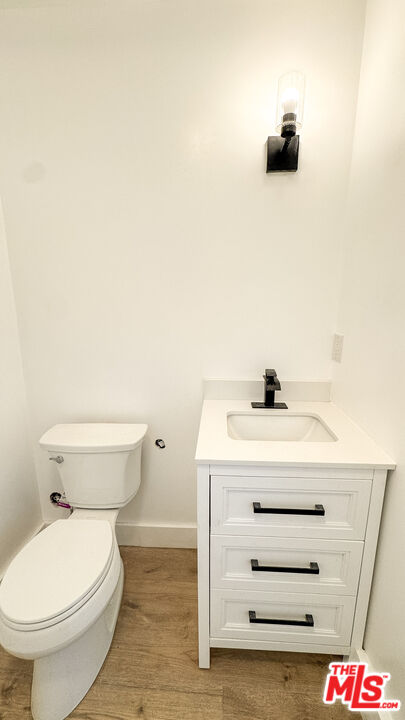 19557 Calvert Street Tarzana, CA 91335 - Photo 6 of 11 a bathroom with a sink a toilet and a mirror