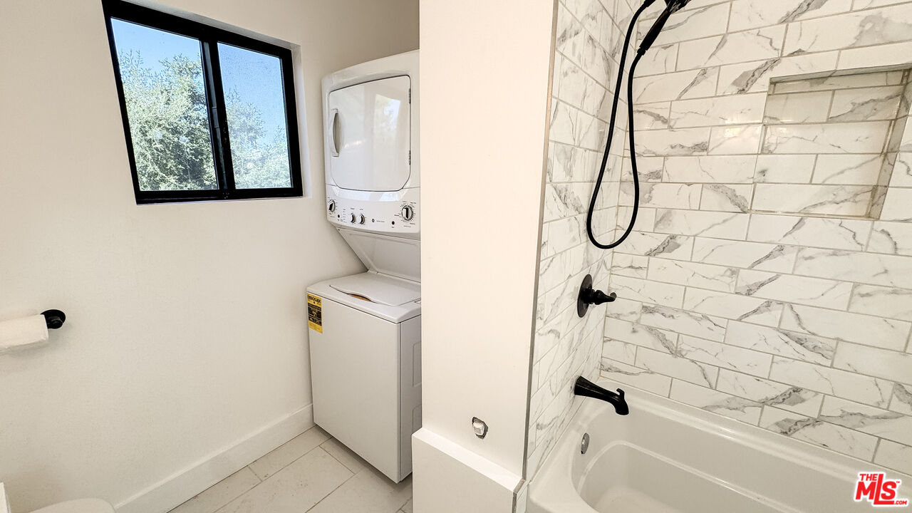 19557 Calvert Street Tarzana, CA 91335 - Photo 9 of 11 a bathroom with a shower and a bathtub